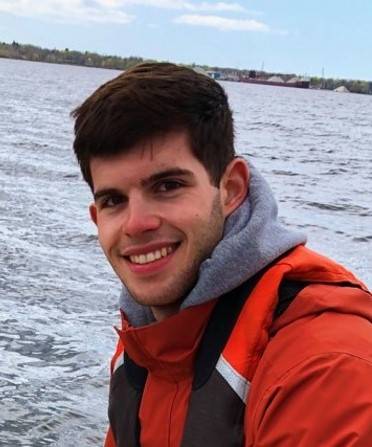 Ian Stone - Undergraduate Student out on a jon boat in Muskegon Lake